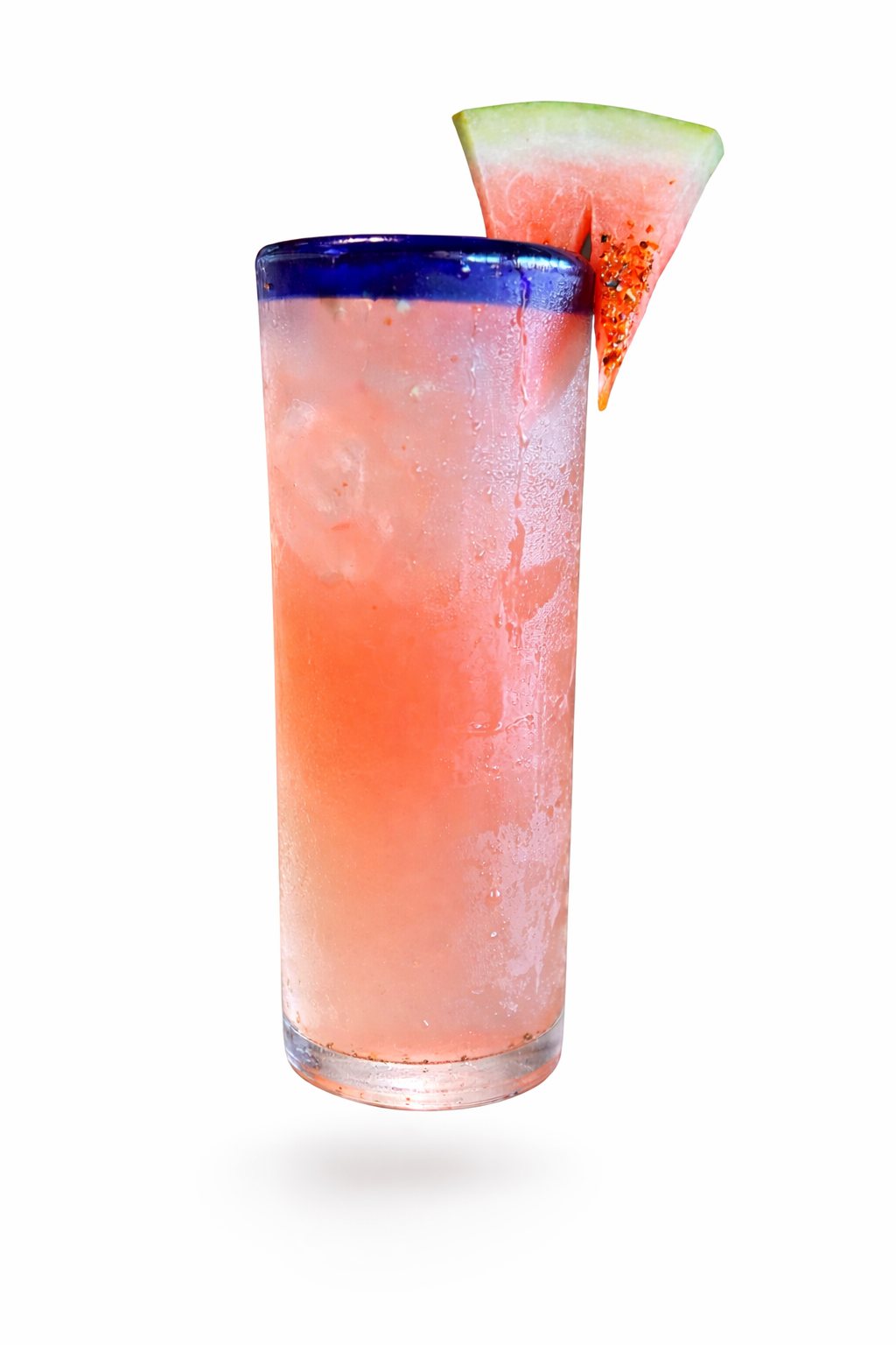 House watermelon cocktail in a blue-rimmed glass